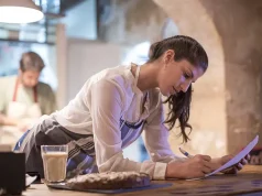 Savoring the World: How Travel Enthusiasts Can Work in Restaurants and Gain Unique Traveling Experiences Restaurant owners working in kitchen