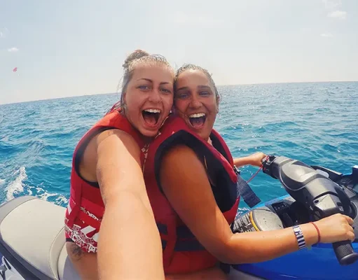 Riding the Waves of Adrenaline: The Dynamic World of Standup Jet Skis lesbian couple on vacation doing water sports on jet ski in ocean