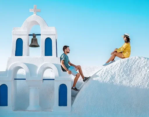 New study reveals the world’s most romantic destinations for a Christmas proposal couple honeymoon on vacation Greece visisting Oia Santorini