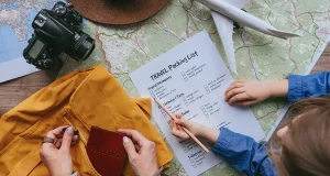 Travel Essentials for Exploring New Destinations Little girl checking travel packing list while her mom putting passport into backpack.