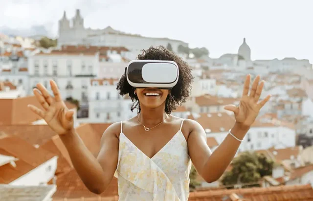 Happy millennial african american woman in vr glasses in city, enjoy summer travel and online game