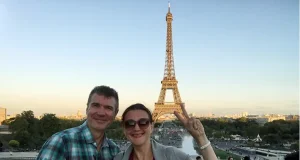 Travel Insurance: What Most Travelers Overlook Before an International Trip Mature couple traveling to Paris and taking selfie with Eiffel tower in background