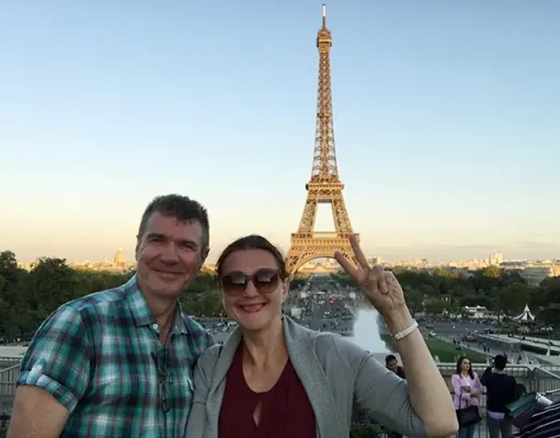 Globetrotting vs. Crash Gambling: Choosing Exploration Mature couple traveling to Paris and taking selfie with Eiffel tower in background