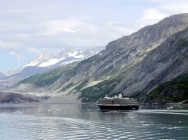 View of the mountains & a cruise ship in the Inside Passage Alaska United States.