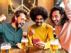 Bet, Win, Explore: Incorporating Real Money Online Gambling into Your Travel Budget Three excited multiracial friends celebrating winning online bet on match