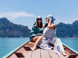 Two happy woman tourist at lake friends in silk suit and scarf and sunglasses on vacation