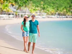 Saint Lucia Retains Its Crown As The World’s Leading Honeymoon Destination Young couple on white beach. Happy family on honeymoon vacation