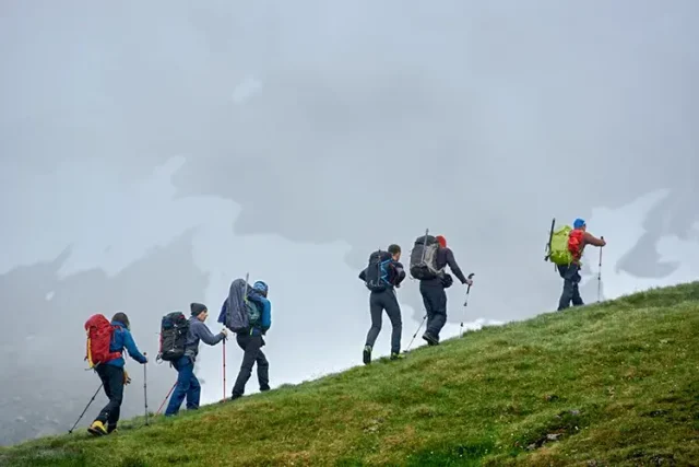 group of travelers climbing the mountain