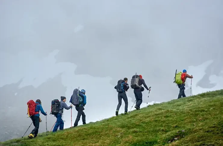 group of travelers climbing the mountain
