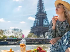 Travel experts reveal the top European cities for food lovers A woman near the Eiffel Tower drinks wine