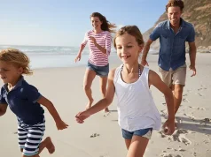 Top Picks for Spring Break 2024 from Hilton.com Parents Running Along Beach With Children On Spring Break Vacation