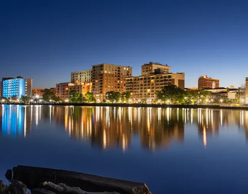 Things to Do with Kids in Wilmington NC Wilmington, North Carolina, USA downtown city skyline on the Cape Fear River at night.