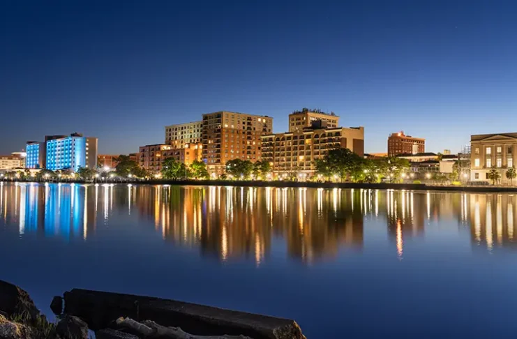 Wilmington, North Carolina, USA downtown city skyline on the Cape Fear River at night.