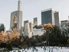 Essential Preparations for Your Extended Stay in NYC People ice skating in the park with buildings in the back