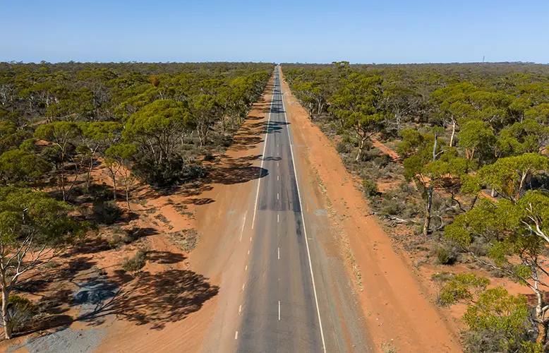 aerial-low-angle-view-of-a-long-straight-road-in-t-2023-11-27-05-04-35-utc copy