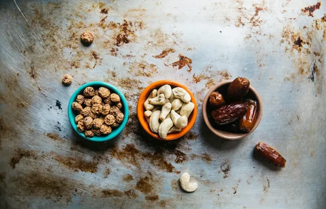 three bowls of nuts for snacking