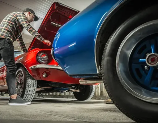 Balancing Performance And Style: How To Choose Wheels For Your Muscle Car American Classic Cars Enthusiast in His 30s Working on His Vehicle