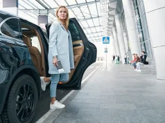 How To Arrange Your Airport Transfers Tension Free With A Limousine Woman with boarding ticket in her hand leaving car