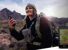 Garmin announces new Montana handheld GPS person hiking with a Garmin Montana 710i GPS in her hand