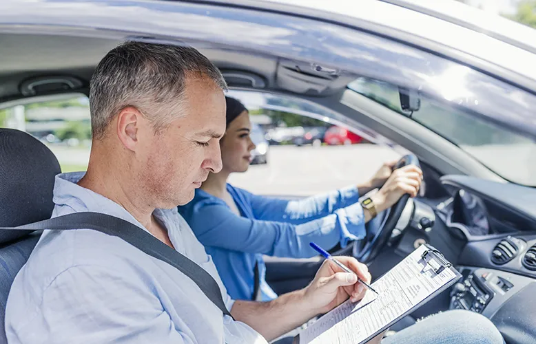 instructor-driving-school-giving-exam-while-sitting-car copy