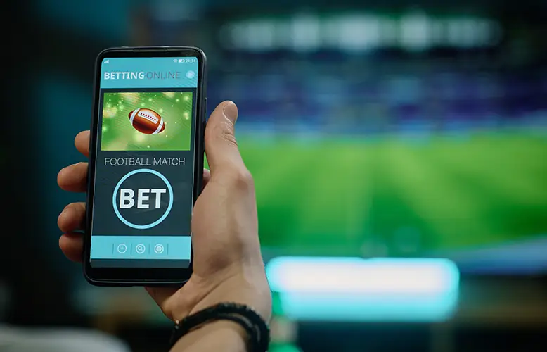 unrecognizable-man-betting-football-team copy