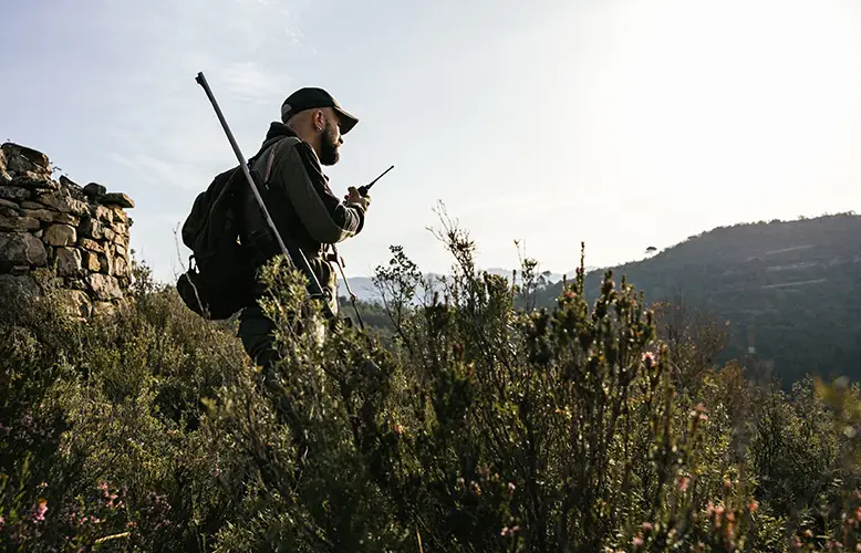hunter-using-walkie-talkie-on-mountain-top-during-2025-01-10-04-28-05-utc copy