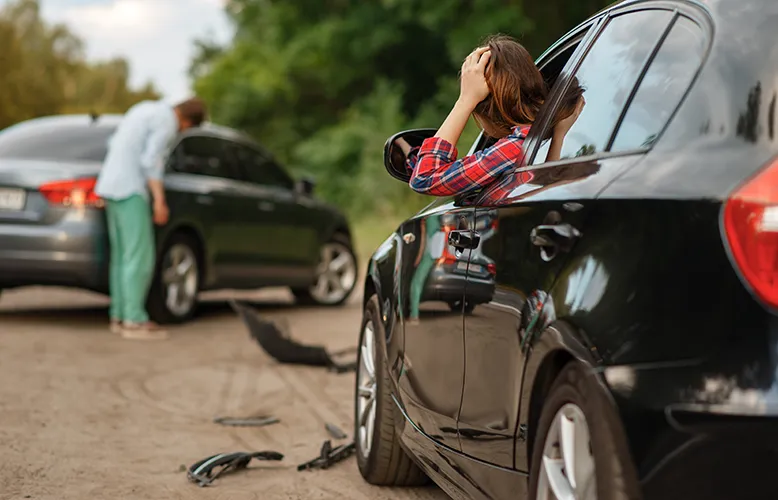 male-and-female-drivers-after-car-accident-on-road-2024-12-05-19-00-26-utc copy