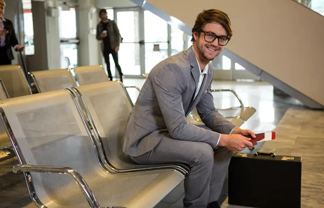 businessman-with-passport-boarding-pass-briefcase-sitting-waiting-area copy