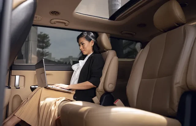 businesswoman-sitting-backseat-taxi copy