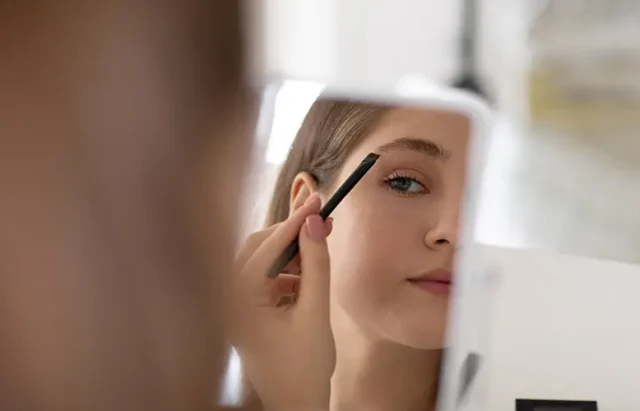 front-view-girl-doing-her-eyebrows copy
