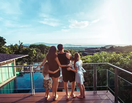 The SPL Villas guide to choosing your family villa holiday Family in the terrace by the sea, watching the sunset.