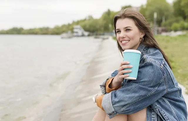 smiley-woman-with-coffee-seaside copy