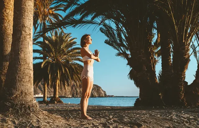 young-woman-doing-yoga-on-the-beach-2025-03-05-13-05-48-utc copy