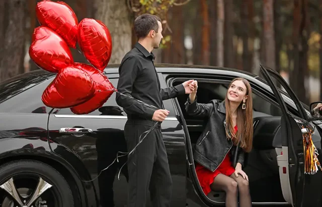 man-with-air-balloons-helping-his-girlfriend-get-out-car-valentine-s-day-celebration copy