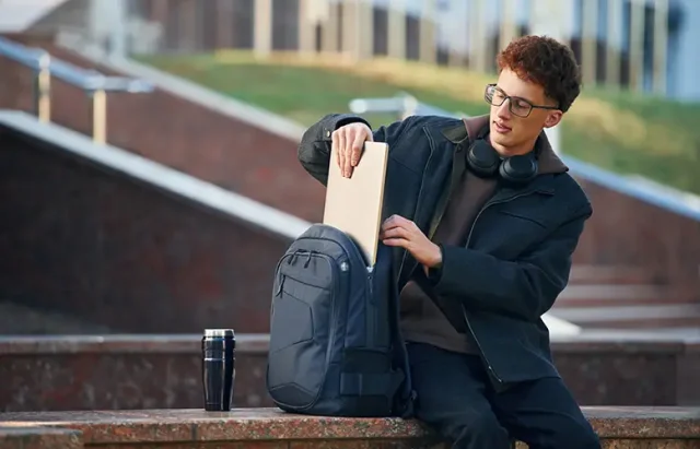 taking-out-laptop-from-backpack-young-student-is-2025-03-18-21-33-04-utc copy