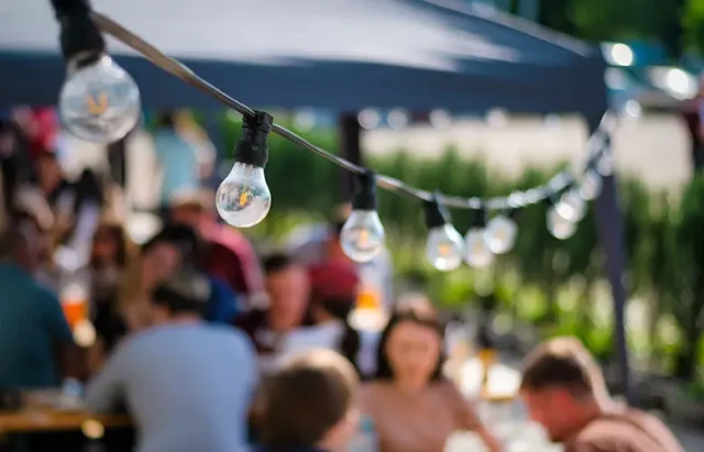 hanged-lamps-outdoor-restaurant-with-multiple-visitors-background-bbq copy