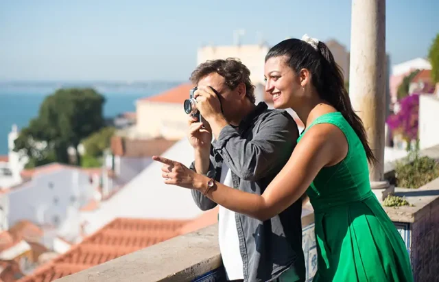 portrait-loving-couple-taking-photos-summer-sea-city-happy-man-woman-standing-city-upland-enjoying-rest-man-taking-photos-faraway-sea-love-vacation-travelling-concept copy