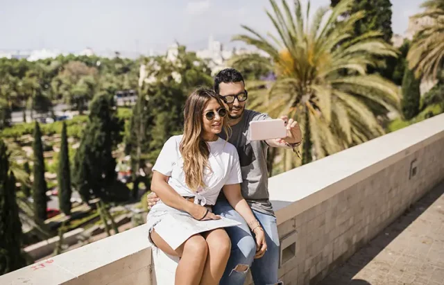 tourist-couple-taking-self-portrait-cell-phone copy