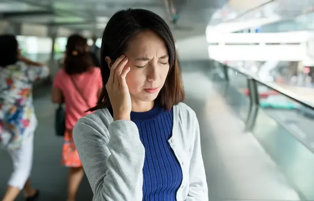 woman-feeling-headache-in-the-foot-bridge-2025-03-25-20-15-42-utc copy