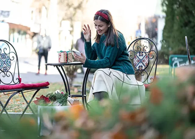 attractive-young-woman-uses-smartphone-christmas-online-shopping copy