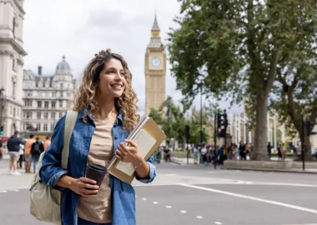 iStock-exchange-student-walking-outdoors-in-london-and-drinking-coffee