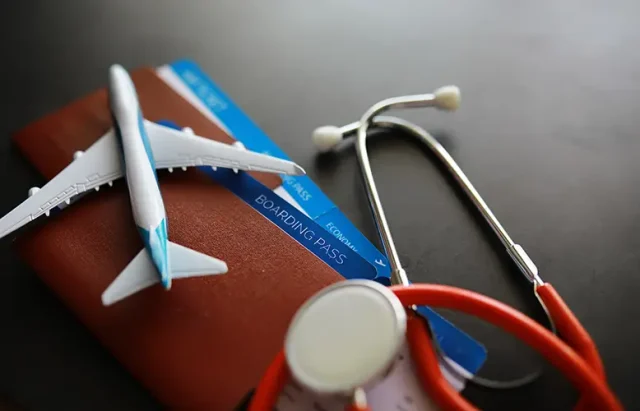 passenger-air-insurance-concept-airplane-passport-boarding-pass-stethoscope copy