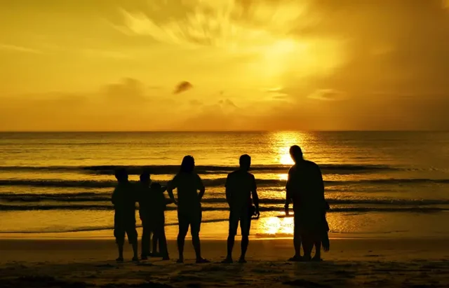 silhouette-people-standing-beach-against-sky-sunset copy