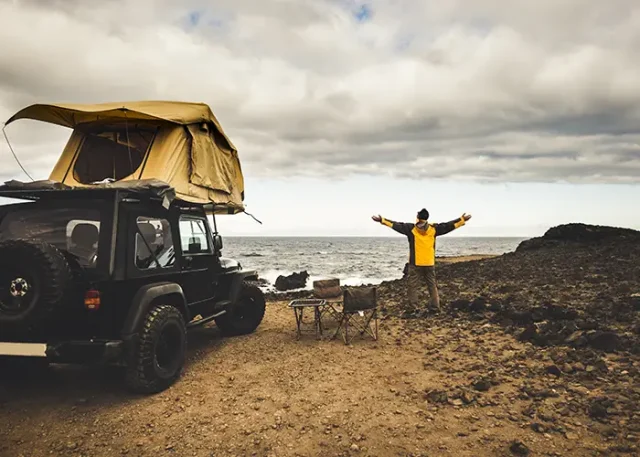 adventurer-man-journey-travel-with-off-road-car-roof-tent-enjoy-freedom-explorer-concept-discover-world-living-near-power-nature-ocean-coast-home-view copy