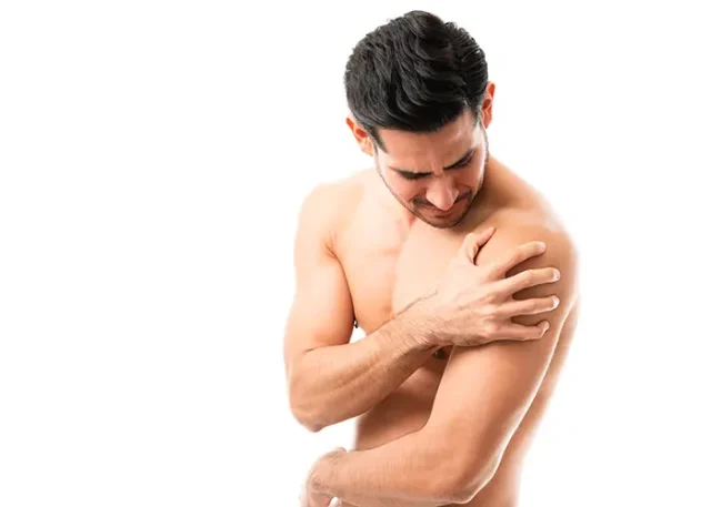 shirtless-young-man-suffering-from-muscle-pain-his-shoulder-against-plain-background copy