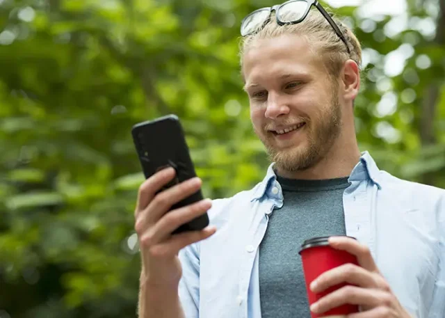 front-view-smiley-man-talking-phone copy