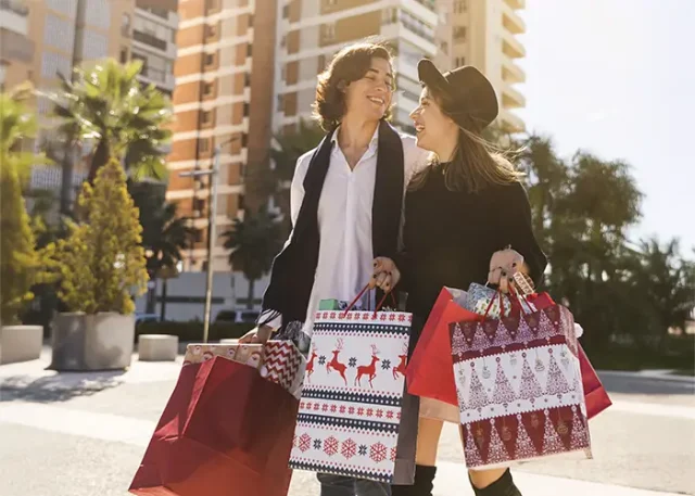 happy-couple-walking-with-christmas-shopping-bags copy
