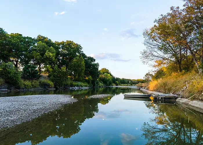 A river with trees and a boat