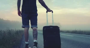 Why San Antonio Is One of the Best Cities for Slow Travel A person walking with a suitcase on the road