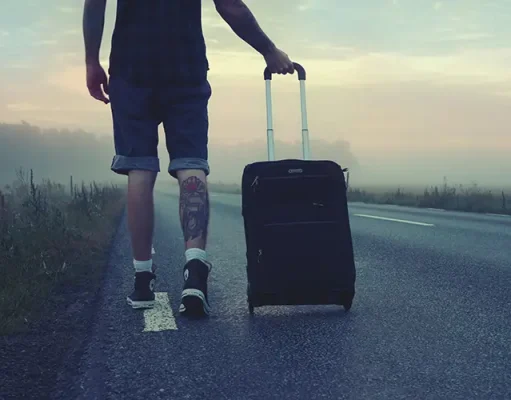 Why San Antonio Is One of the Best Cities for Slow Travel A person walking with a suitcase on the road